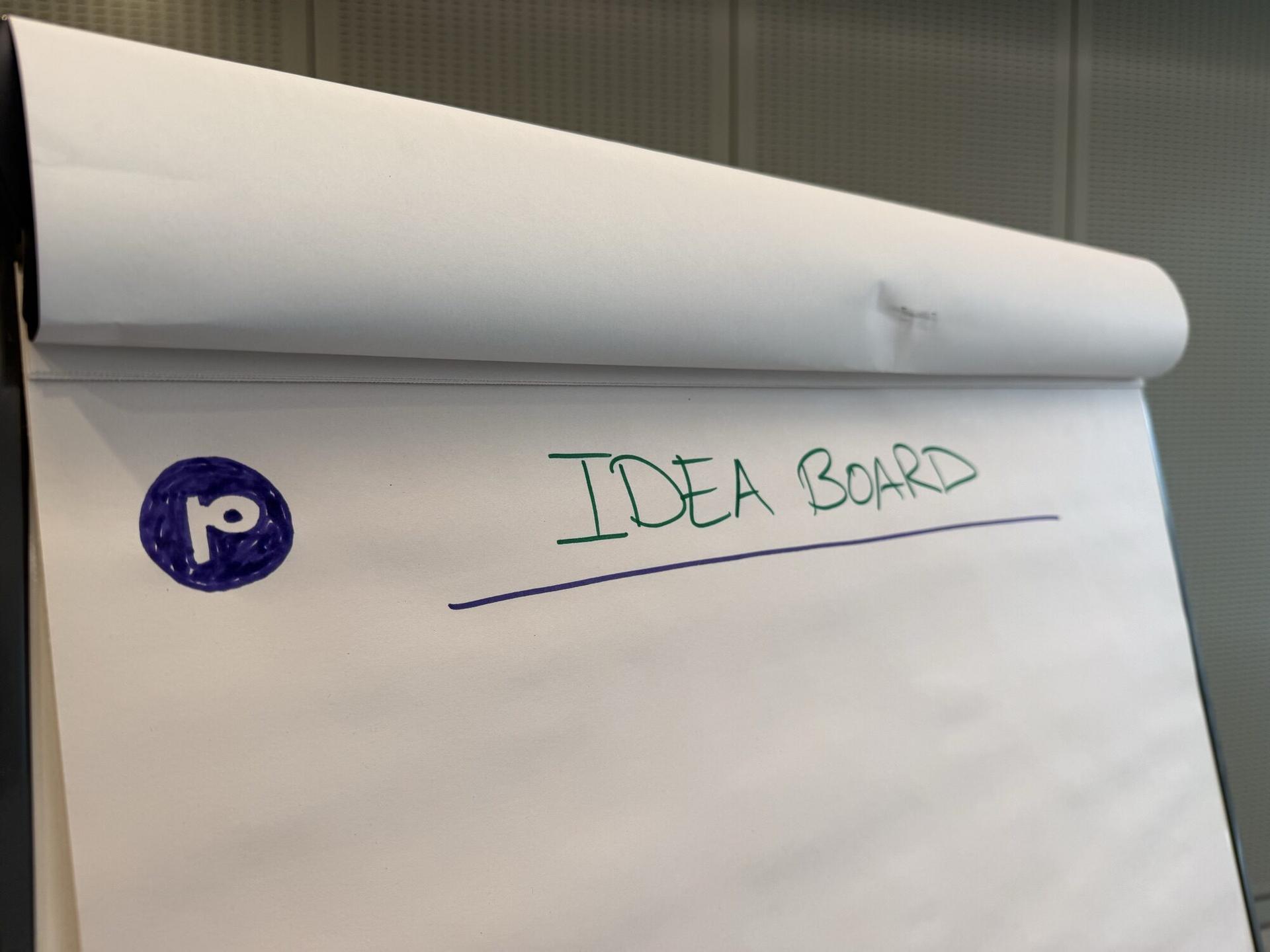 The idea board at a Purple workshop, headed Idea Board with the Purple mark drawn in marker